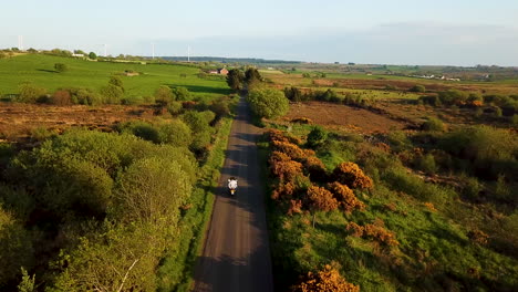 drone shot tracking two people on a motorcycle in ballymoney