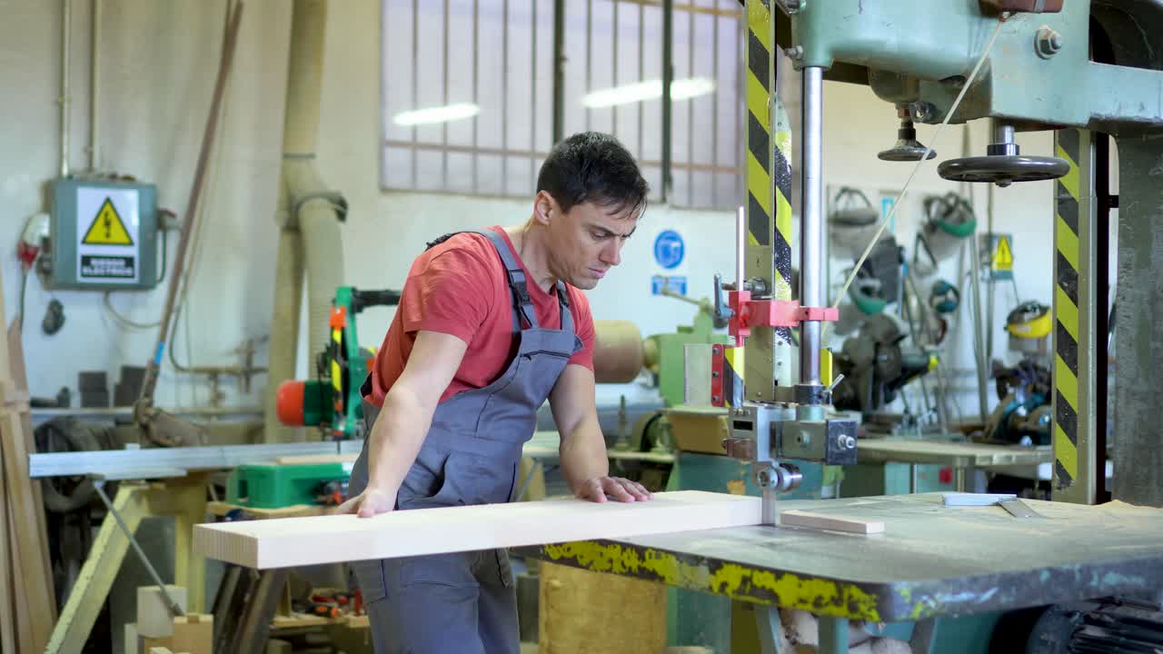 Carpenter working with a band saw in a workshop