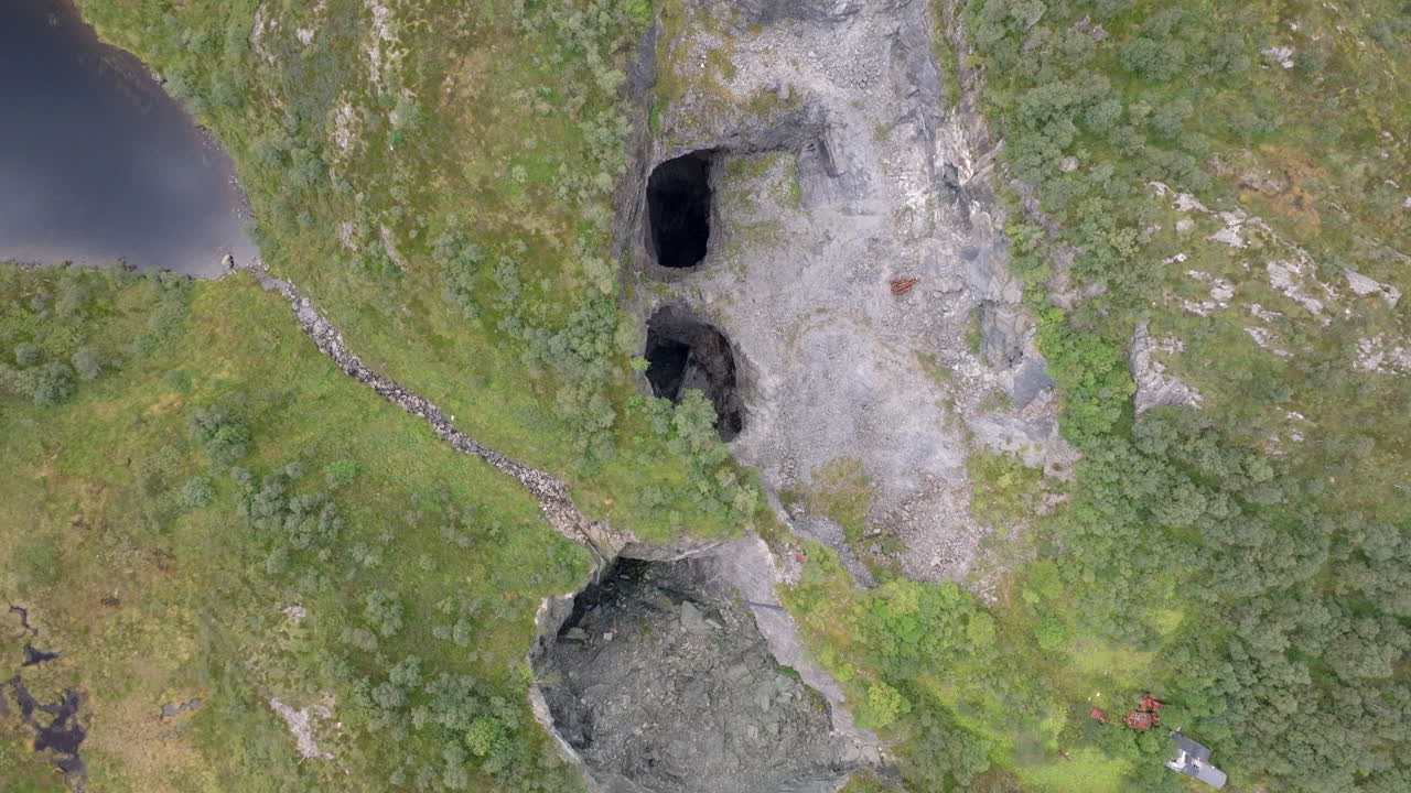 Aerial footage of deserted lime mines in the Norwegian wilderness, with rugged cliffs and dramatic natural surroundings