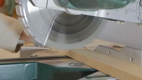 young girl carpenter cuts wood material with a circular saw. she moves the saw into place and removes the workpiece. a woman works with wood products. 4k