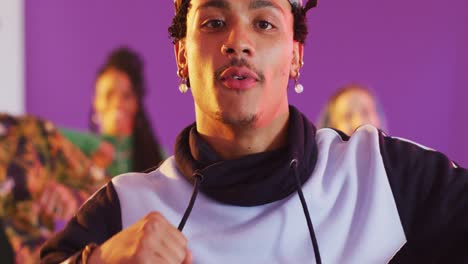 portrait of happy diverse male and female dancers dancing in dance studio, slow motion