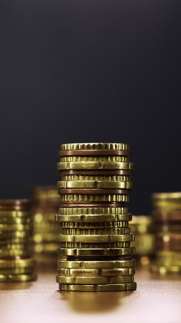 Stop-motion animation of gold coin stack steadily decreasing to nothing, visualising dwindling savings, inflation and economic pressure