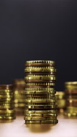 stop-motion animation of gold coin stack steadily decreasing to nothing, visualising dwindling savings, inflation and economic pressure