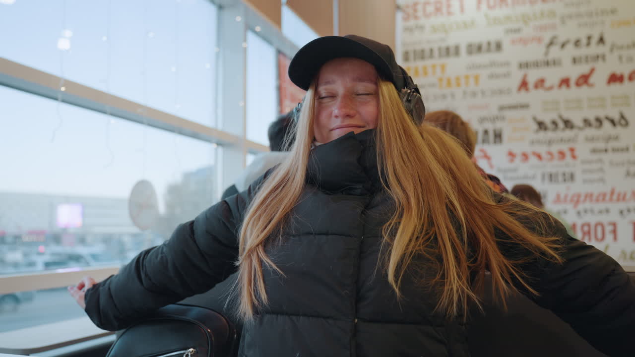 Relaxed traveler enjoying layover. Casual scene with woman at airport. Portrait of woman smiling during airport stopover. Informal snapshot of woman resting at airport terminal with joyful expression