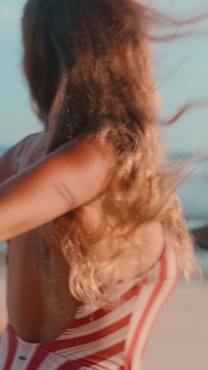 Young couple enjoys relaxing moments by the ocean shore at sunset