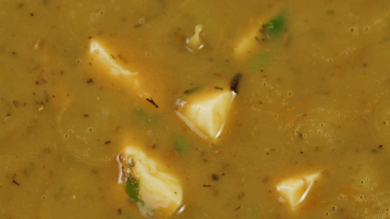 Cooking traditional Indian meal Palak Panir with spinach and cheese close up. Palak paneer is an Indian dish, consisting of paneer in a thick paste made from pureed spinach, Palak paneer is prepared by first boiling and pureeing spinach.