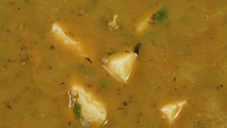 cooking traditional indian meal palak panir with spinach and cheese close up. palak paneer is an indian dish, consisting of paneer in a thick paste made from pureed spinach, palak paneer is prepared by first boiling and pureeing spinach.