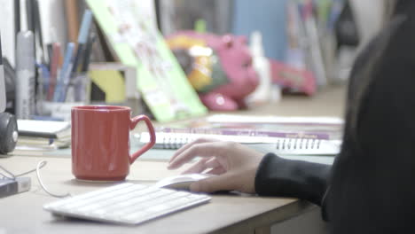 beautiful woman designer working in front of a computer with glasses