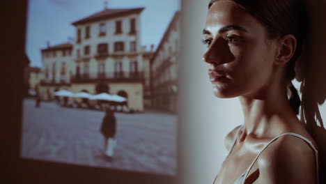 pensive woman against an urban projection