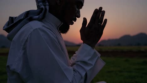 muslim man praying at sunset