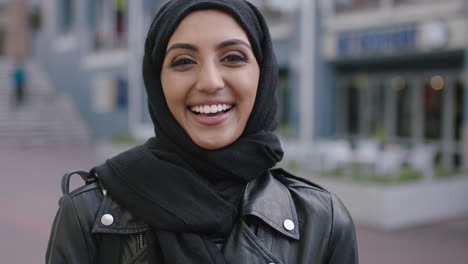 portrait-of-young-muslim-woman-laughing-happy-enjoying-city-life-wearing-leather-jacket