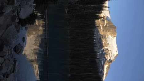 Vertical-View-Of-Reflections-Over-Tranquil-Water-At-Joffre-Lakes-Provincial-Park-In-Pemberton,-British-Columbia,-Canada