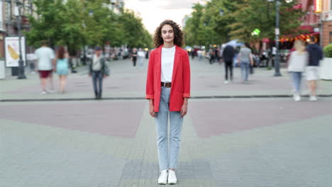 young woman in red blazer on city street