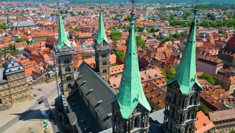 4k aerial drone video of the beautiful copper spires on the bell towers of the bamberg cathedral in the old town area of bamberg, germany