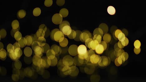 Multiple-yellow-fairy-lights-glowing-on-black-background