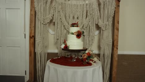 beautiful wedding cake and flower arrangement at reception