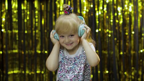 Child-dances,-listens-music-on-headphones.-Little-kid-girl-dancing,-having-hun,-relaxing,-enjoying