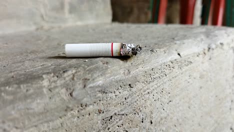 close-up of a cigarette with a beautiful puff of smoke when placed