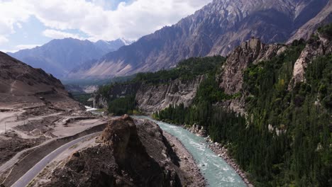aerial clip of hunza valley, hunza river, karakoram highway, and spectacular karakoram mountain range in the distance.