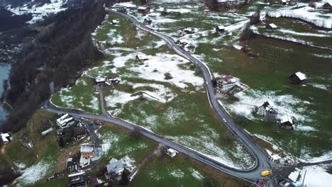 different cars driving down a mountain road in amden, switzerland