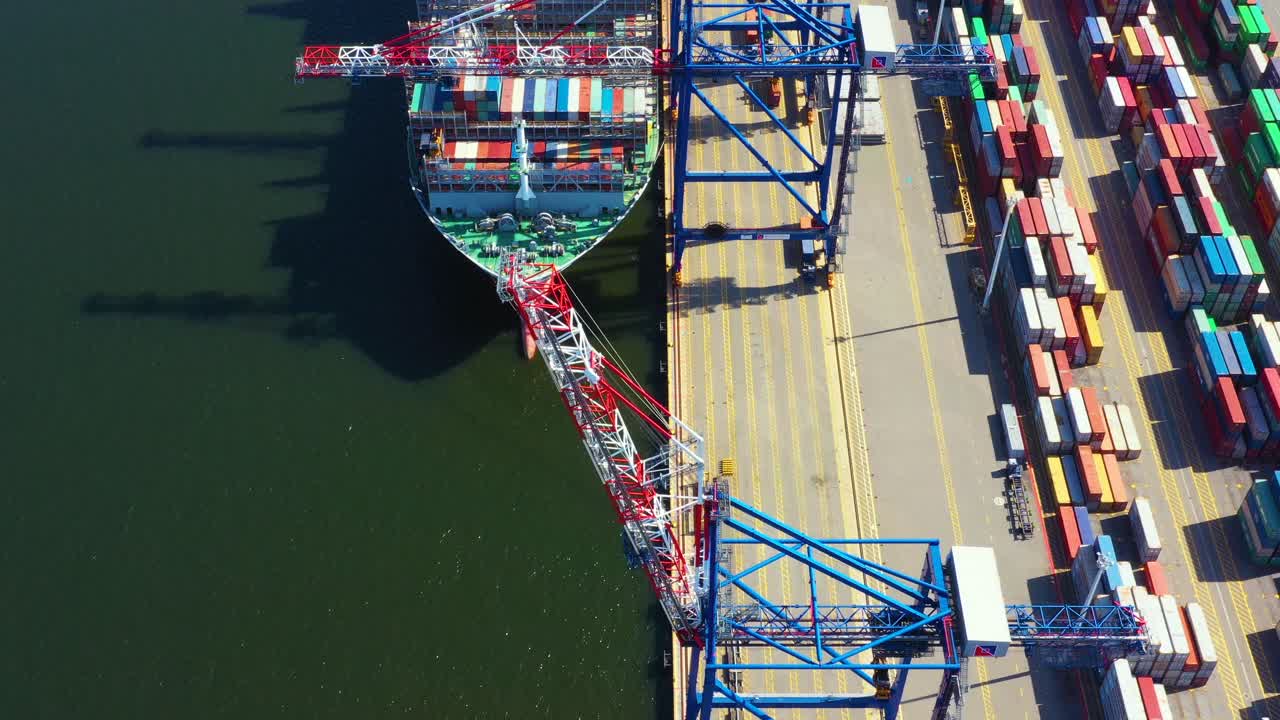 Container ship loading at port with crane, container ship carrying container import and export business logistic and transportation, Aerial top view
