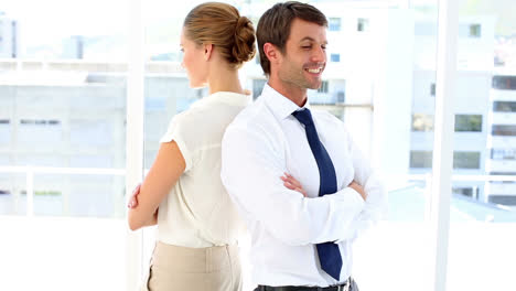 proud business team standing back-to-back