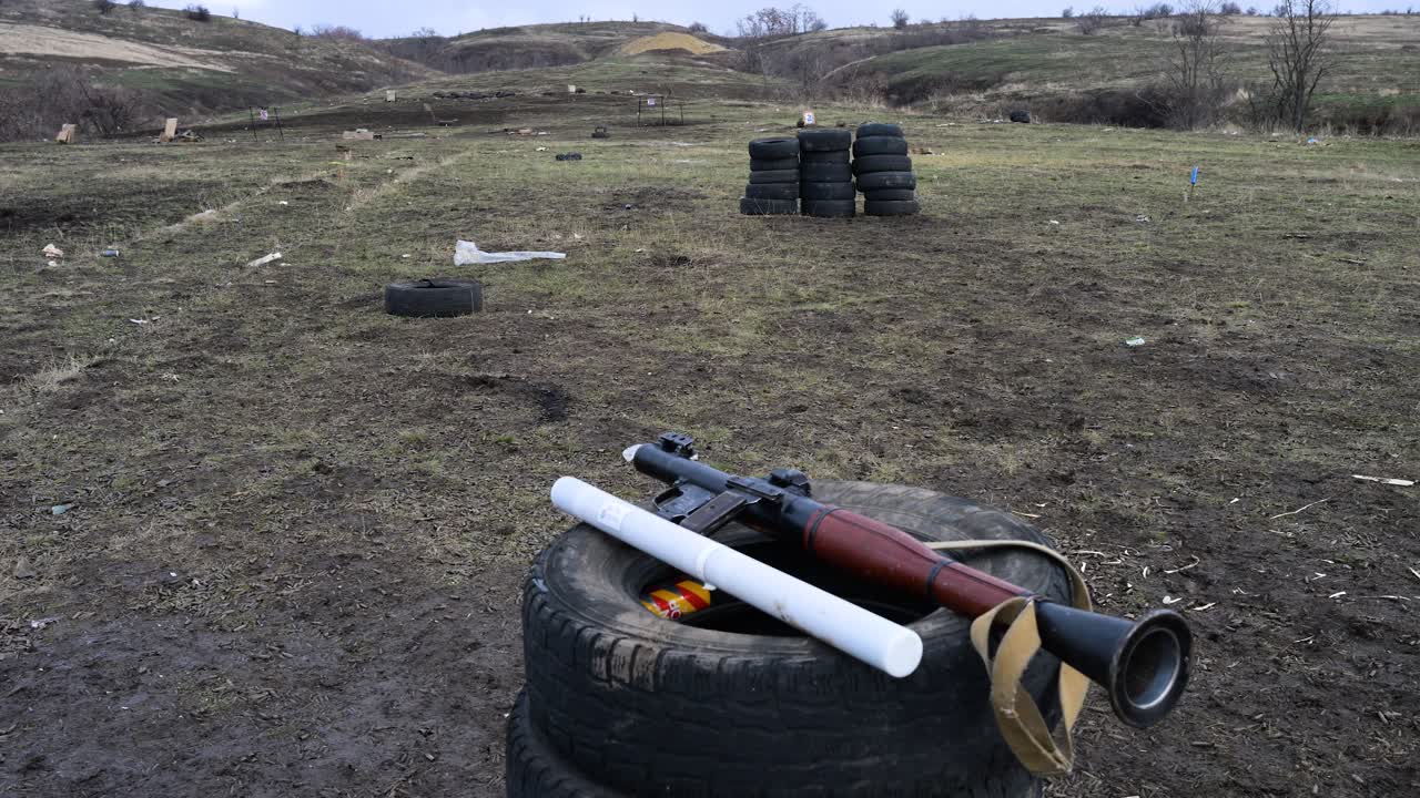 A static shot of an RPG-7 rocket launcher and a rocket prepared for a live-fire training exercise at a Ukrainian military range, honing skills for the ongoing war with Russia