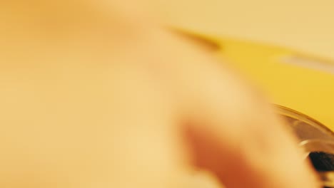 vintage yellow rotary phone closeup