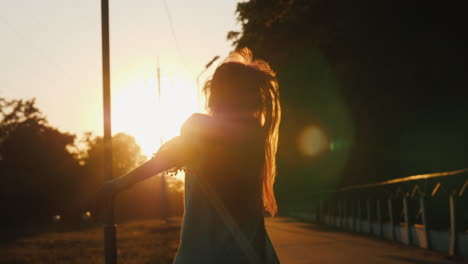 cheerful girl with a satchel behind her back runs towards the camera back to school