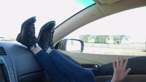 girl moving her legs and arm in the car.