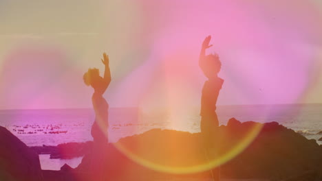 dancing on rocky beach, people with colorful animation light effects