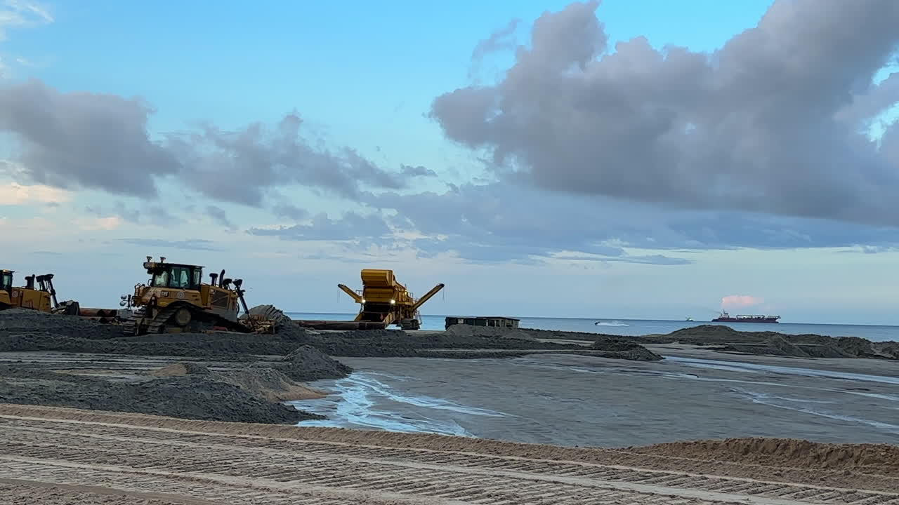 Blue sky at beach during sand replenishment and shoreline reclaim