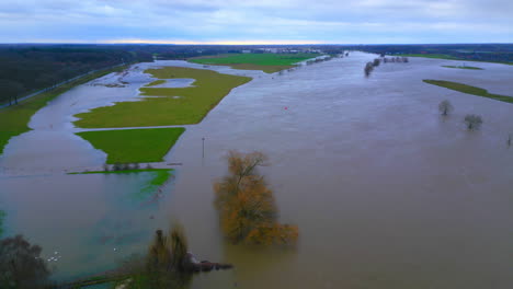 overflowing dikes in the limburg landscape after flooding causing fields to be flooded