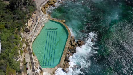 popular seaside destination featuring a saltwater rock pool - bronte baths in bronte, nsw, australia - aerial, top down