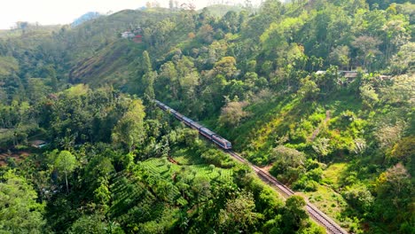 breathtaking aerial drone footage of a train crossing the iconic nine arches bridge in ella, sri lanka.
