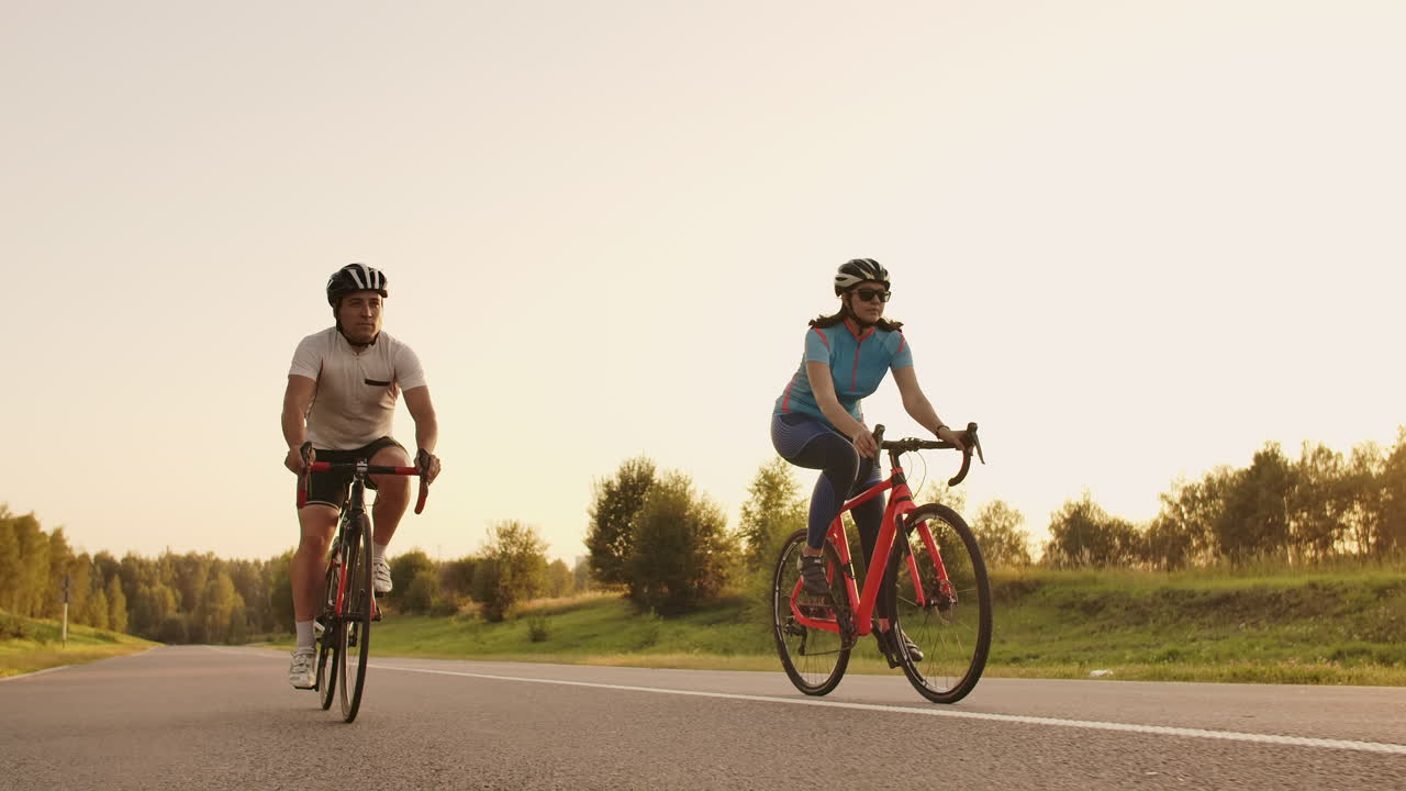 Tracking shot of a group of cyclists on country road. Fully released for commercial use.