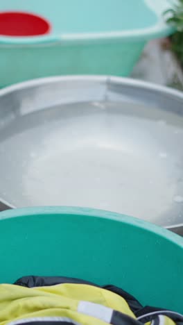 basins with clothes and water