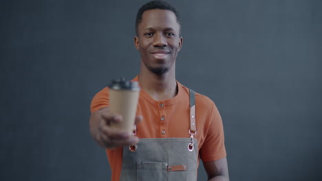 smiling barista holding coffee cup