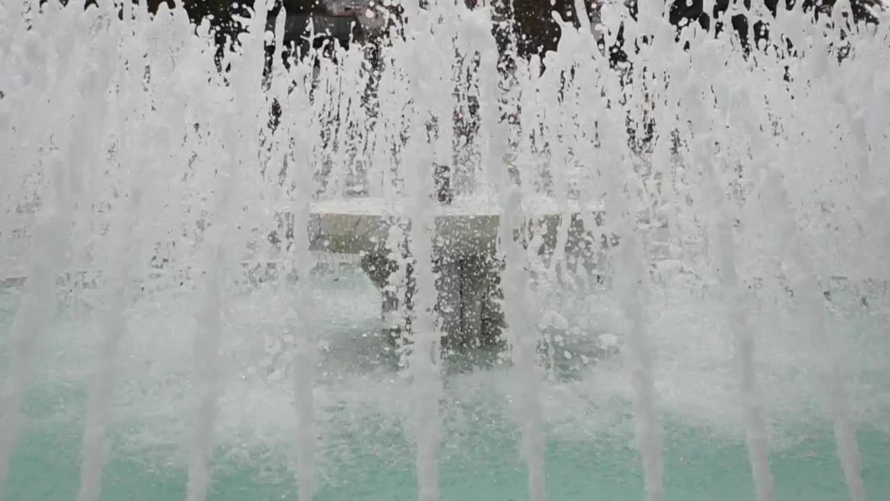 A close-up view of a fountain, showing the water spraying up and out