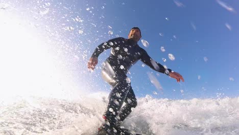 surfer on blue ocean wave surfing getting barreled