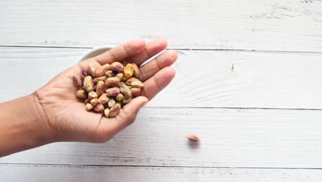 Close-up-of-pistachios-nut-on-hand