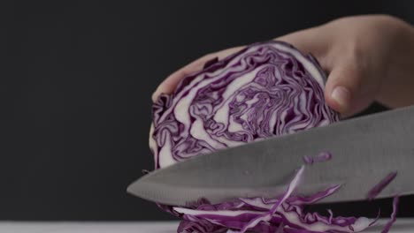 cutting the cabbage into small pieces with a knife.