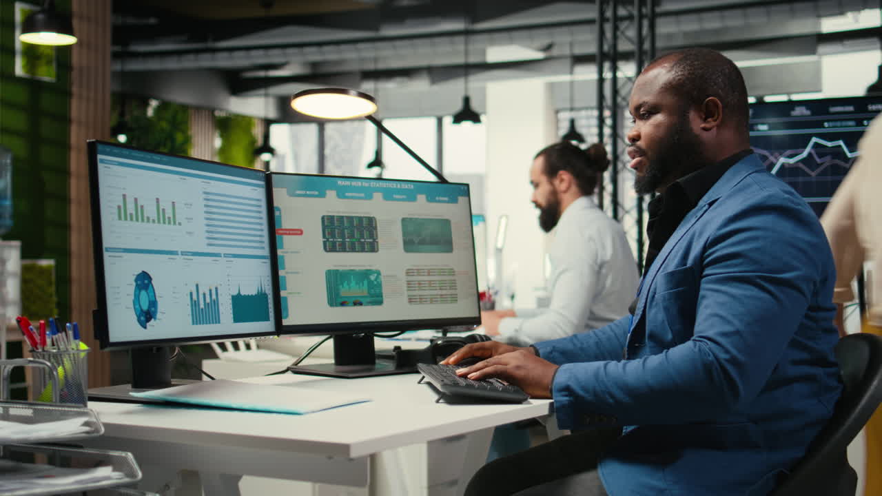 Vertical Video African american office worker leverages analytics and report writing