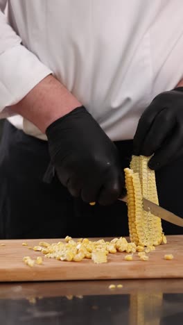 chef cutting corn on the cob