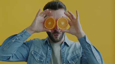 man with oranges over eyes