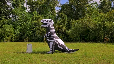 inflatable dinosaur setting up and operating drone taking off