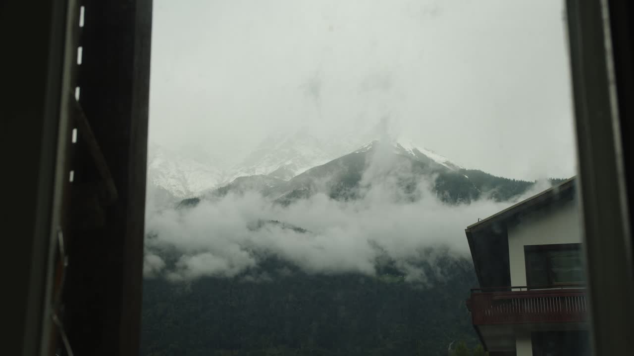 Slow-moving time-lapse of soft clouds seen through a window. Ideal for meditation, stillness, or introspective visual design
