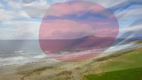 Digital-composition-of-waving-japan-flag-against-aerial-view-of-sea-waves