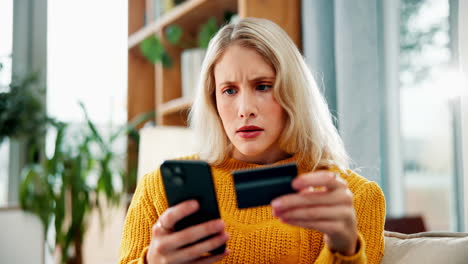 woman looking worried with credit card and phone