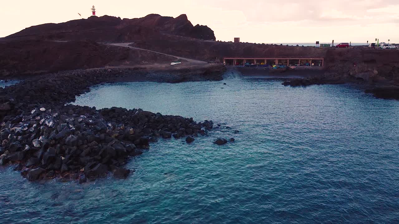 Drone fly over of bay at sunset near Lighthouse la Punta de Teno on Tenerife island